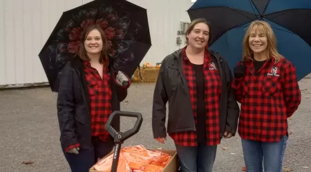 AAACU Team members taking a selfie as they clean up trash in their community
